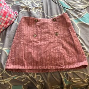 Stretchy rose colored mini skirt.